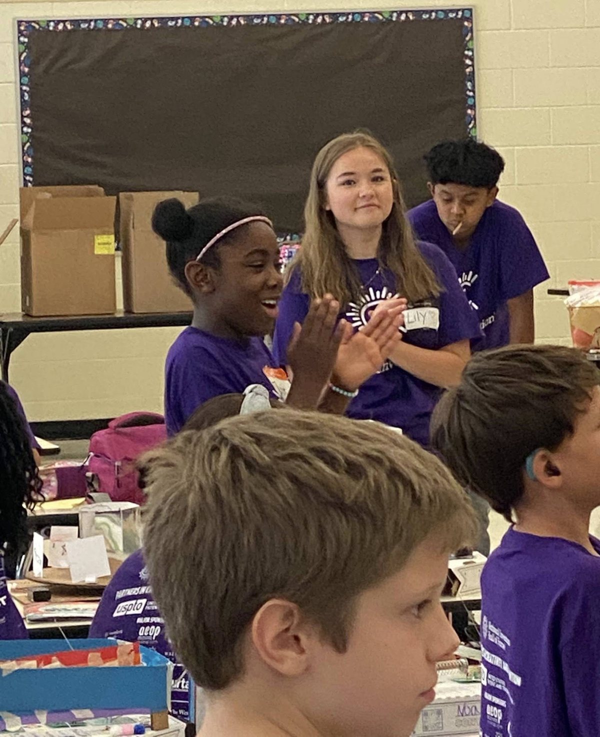 Lily helping at a summer STEM camp activity